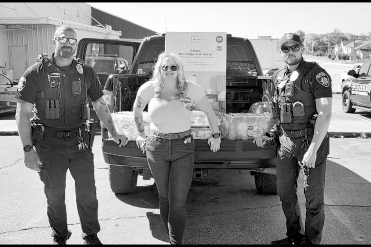 The summer heat just doesn’t seem to want to lessen its grip, so Seminole Walmart wanted to make sure local police officers keep cool while they’re working. The store donated a mini fridge, cases of water and sandwiches to the Seminole Fraternal Order of Police to help keep officers fed and hydrated on the job. Pictured with Walmart employee Katie are Officers Bohannon and Sanor. —Courtesy photo