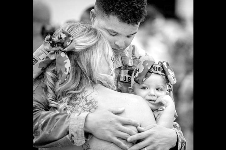An Oklahoma Army National Guard Soldier assigned to the 745th Military Police Detachment, 345th Combat Sustainment Support Battalion, 90th Troop Command, Oklahoma Army National Guard, hugs his family during the unit’s welcome home ceremony in Mustang, Oklahoma, Aug. 20, 2026. The Citizen-Soldiers reunited with loved ones during a welcome home ceremony honoring the unit’s nine-month deployment to the U.S. Central Command area of responsibility. (Oklahoma National Guard photo by Anthony Jones)