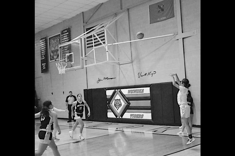 Wewoka Lady Tiger Emma Slovacek takes a shot from three-point range Friday night at home against Okemah. Staff Photo by Bill Anderson