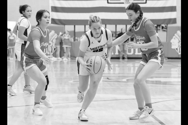 Seminole Lady Chieftain Daisy Wood goes between two defenders on her way to the basket Thursday night. Courtesy Photo by Glen Bryan