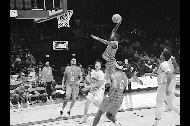 Potawatomi Fire Kam Williams flies in for the slam dunk Friday night against the Clutch. Staff Photo by Bill Anderson
