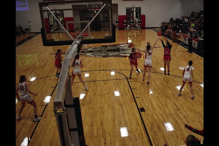 Konawa Lady Tiger Kassidi Lowden shoots from the field over her defender Thursday. Staff Photo by Andy Wilson