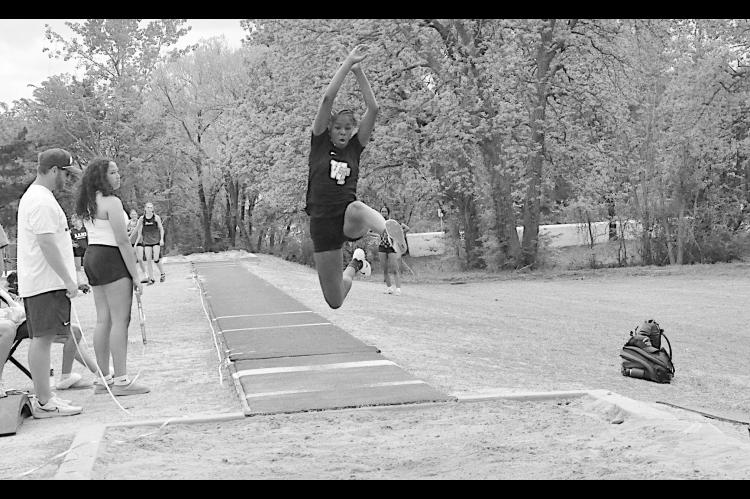 Wewoka Lady Tiger Heavenli Hill leaps into the air during the Long Jump event at Ada. Heavenli Hill placed 2nd Overall with a jump of 16’ 10”. Staff Photo by Bill Anderson
