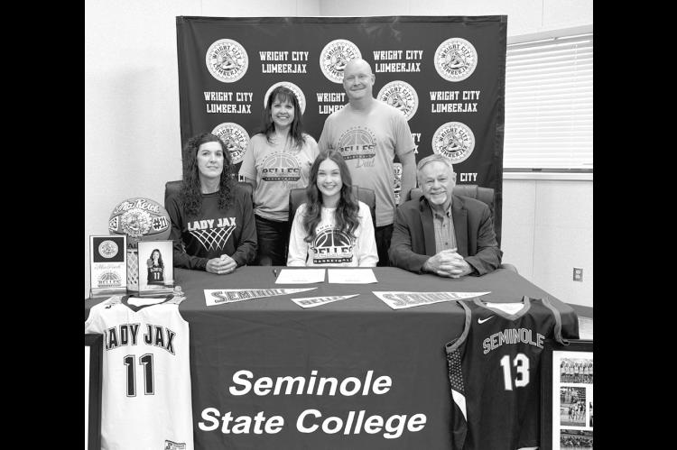 Mia Reich of Wright City High School has signed a letter of intent to play basketball for Seminole State College. Pictured sitting l-r: Wright City basketball coach Misty Haley, Mia Reich and Seminole State Coach Randy Wassam. Standing are Mia’s parents