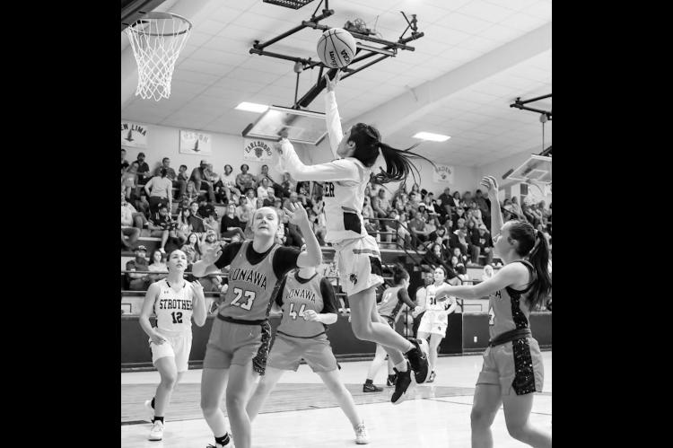 Strother Lady Yellowjacket Danica Morales puts up a basket attempt over the defensive effort of Konawa’s Kakie Jencik. Courtesy Photo by Glen Bryan