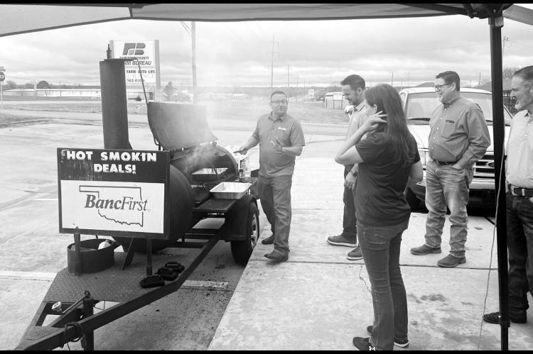 James Whitson, District Manager for Oklahoma Farm Bureau Insurance, cooks up hamburgers during a customer appreciation event held last Friday at the Seminole office on Wrangler. Also pictured are Shawn Streater, Agent; Kari Kiker, Agent; Curt Potter, Spec