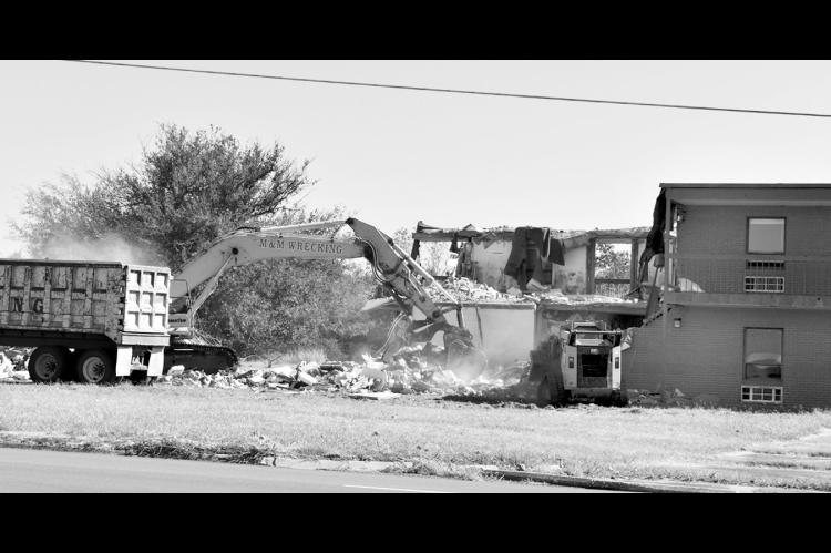 —Staff Photo by Andy Wilson Demolition of the former S.J. Sarkeys Dormitory just across the highway from Seminole State College got underway Wednesday morning. The dorm was approved in early 1982 and finished in 1983 as a 44-bed facility, back when the institution was known as Seminole Junior College, or simply “Juco.” Today, the college has two residential centers: the Roesler Residential Learning Center built in 2000 and the Seminole Nation Residential Learning Center, built in 2008