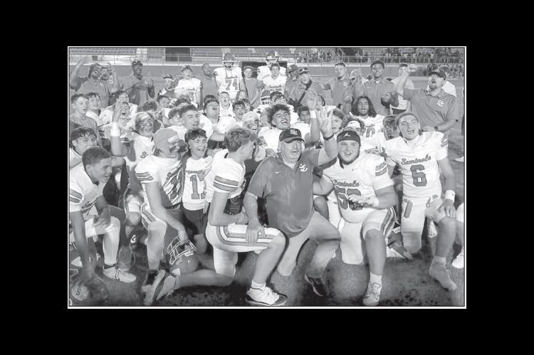 Coach Mike Snyder and the Seminole Chieftains celebrate on the sidelines after the team’s 46-23 victory over NW Classen Friday night. Friday’s win was Snyder’s 400 t ' 1 career win. Snyder started with Seminole Public Schools in 1972 and became head football coach in 1980. —Staff Photo by Bill Anderson