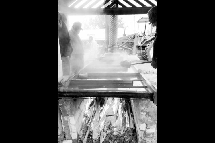Steam rises from the pan as raw cane juice slowly caramelizes into sorghum syrup in this undated photo from the Wewoka Sorghum Festival. The woodfired furnace is integral to the process of making the centuries-old sweetener. A grant from ORRC will help prolong the life of the historic structure located on the grounds of the Seminole Nation Museum in Wewoka. (Photo provided)