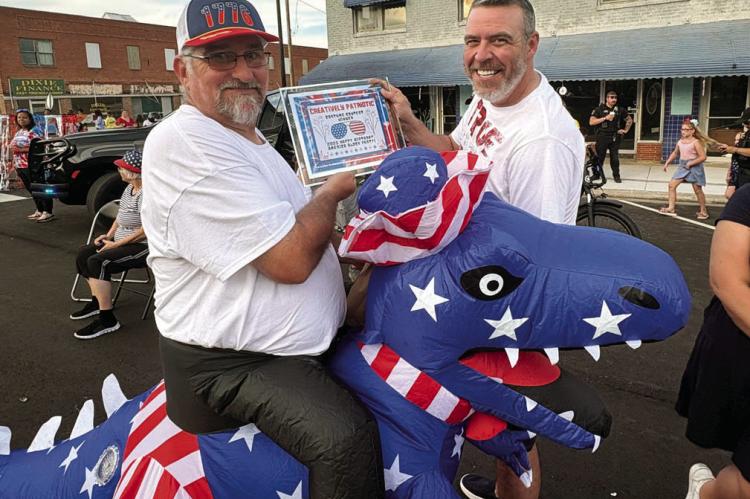 Seminole City Councilman Scott Rossman, who represents Ward Two, won second place for creativity at the “Happy Birthday USA” block party Tuesday evening, sponsored by the Seminole Arts Council. Pictured with Rossman is Mayor Cory Crabtree. —Courtesy
