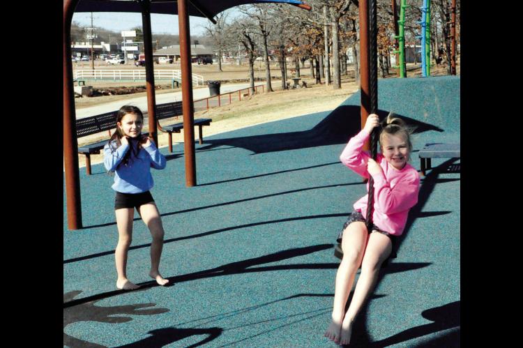 Sophia Hines and Tatum Batchelor, both barefoot and clad in shorts, ventured out Friday afternoon to swing and grab some sunshine at Boom Town. Should they do so again this weekend, their feet might be a little warmer, as temps in the 60s are in the forec