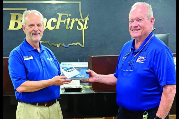 Chris Moore (left), at the most recent Chamber of Commerce Forum, won the Weather Radio given away by Ernie Willis, Emergency Management Director for the City of Seminole. The giveaway was to promote importance of having multiple ways to receive warnings.