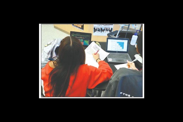 Jenks High School students use laptops and paper worksheets in an advanced chemistry class at the Jenks Public Schools Math and Science Center on Nov. 3, 2024. (Photo by Nuria Martinez-Keel/Oklahoma Voice)