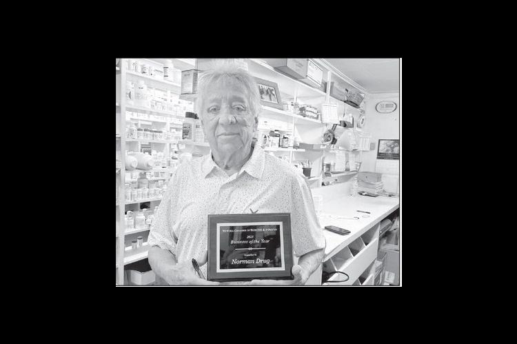 John Norman of Norman Drug in Wewoka holds the plaque he was presented with by the Wewoka Chamber of Business &amp; Industry for 100 years of service to the community. The award was presented at the Chamber’s banquet on March 30. (Courtesy photo)
