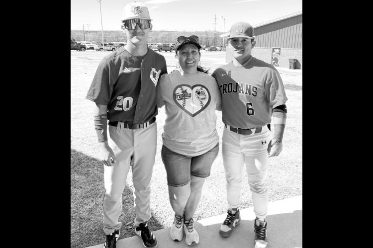 Adriana Tiscareno (center) didn’t have to choose teams when Seminole State played Northeastern Oklahoma A&amp;M this past weekend. Her son Jose (left) plays for NEO and her son Angel plays for Seminole. Rosa showed up in a shirt with both team logos on 