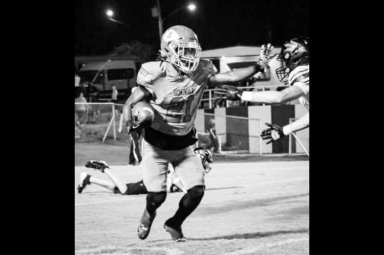 Seminole Chieftain RB Timothy McFadden goes for a stiff arm. Courtesy Photo by Ben Schatzel