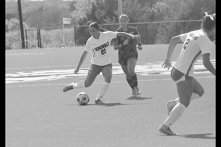 Seminole State Lady Trojan Claire Navarro gets control of the ball and sends the ball downfield to her teammate Sunday afternoon. Staff Photo by Bill Anderson