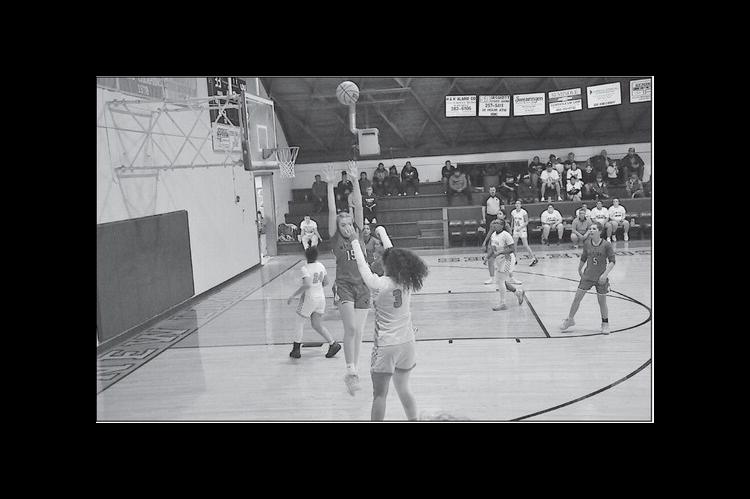 New Lima Falconette Layla Cecil makes the shot from three point range Tuesday night against Wetumka. Staff Photo by Bill Anderson