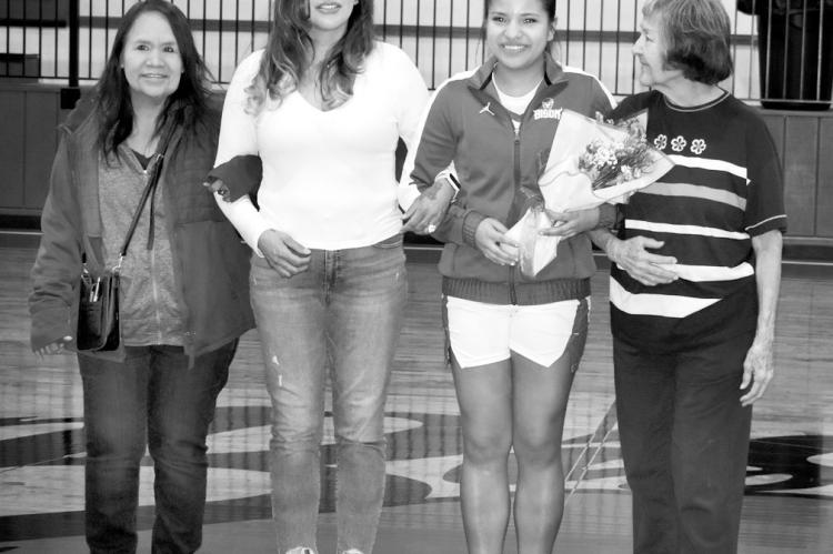 Teyha Coker (second from right), a senior basketball player for the Bowlegs Lady Bison, was honored Friday night before the team’s game against Paoli. Teyha was joined on the court by family members. —Staff Photo by Andy Wilson