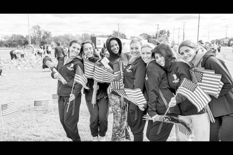Left, SSC women’s soccer players lend a hand planting American flags on SSC’s campus. Pictured from left are Molly-Kate Lundy of Lewisville, Texas; Zoe Trenchard of Lewisville, Texas; Jillian Powell of The Colony, Texas; Bry Russell of Flower Mound, T