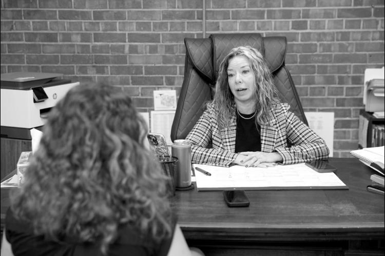 Tracey Halley-Terrell, president of the Oklahoma Bondsman Association Board, is interviewed by Oklahoma Watch intern Maya Henry in her Oklahoma City office on June 10, 2026. (Brent Fuchs/Oklahoma Watch)
