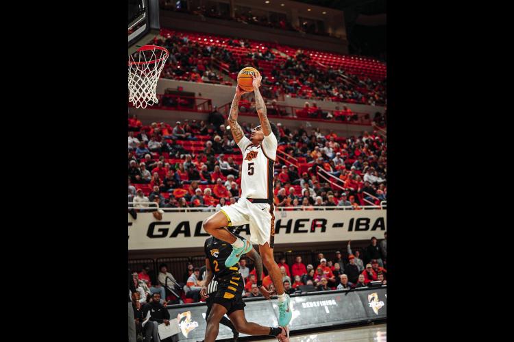 Oklahoma State’s Vyctorius Miller flies in for the easy two. Courtesy Photo by Ben Schatzel