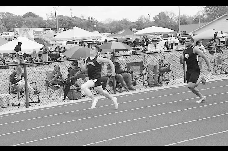 Konawa Tiger Mason Davis sprints to the finish line, followed directly by Wewoka Tiger Mike Piza Friday at Ada. Staff Photo by Bill Anderson