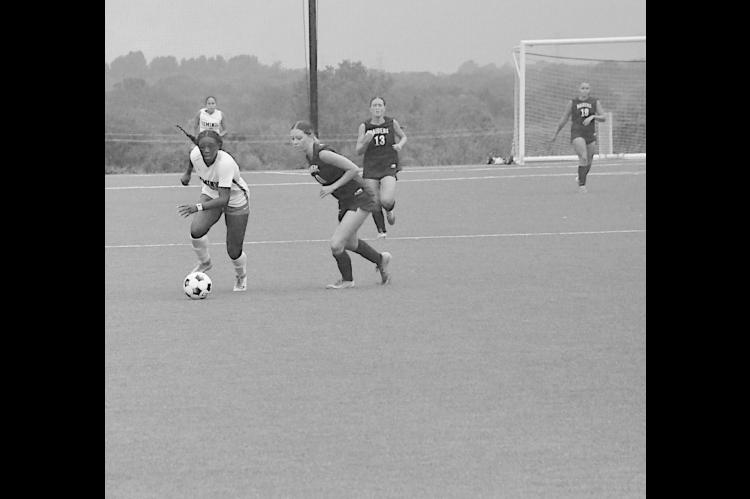 Seminole State Lady Trojan Kamora Haralson drives the ball down the field Sunday. Staff Photo by Bill Anderson