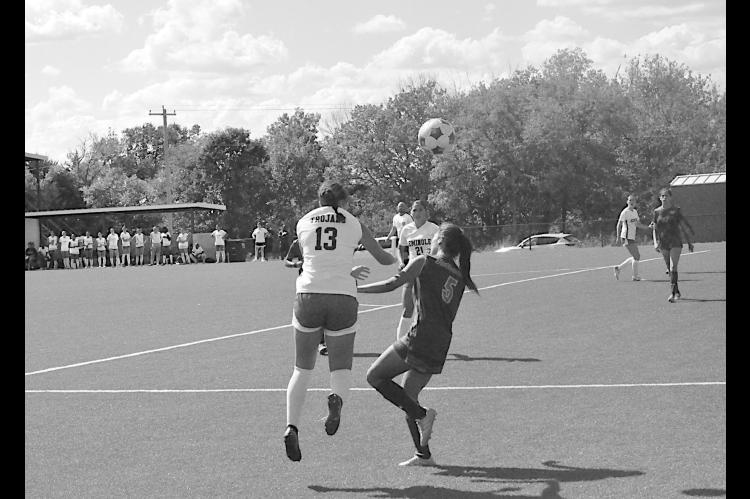 Seminole State Lady Trojan Gracie Lee keeps the ball in play for the Trojans by using her head Sunday afternoon. Seminole State won 8-0 Staff Photo by Bill Anderson