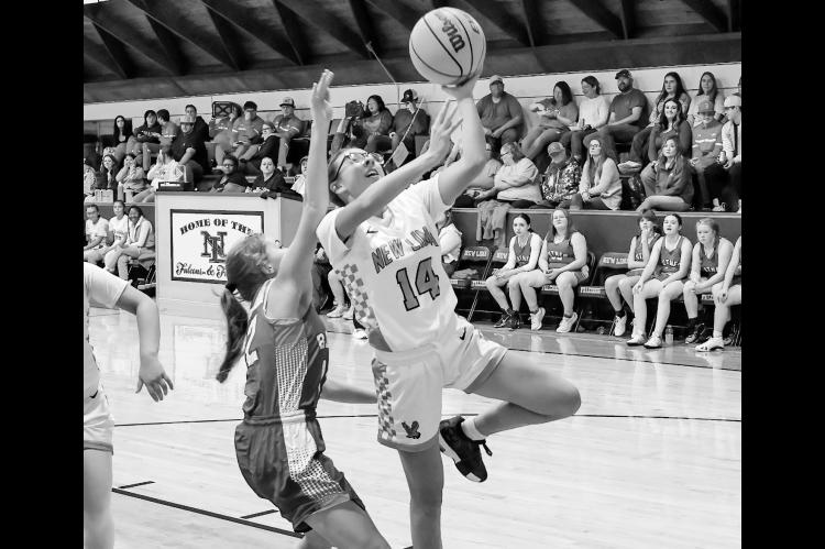 New Lima Falconette Jazzy Harjo gets past Butner’s defender Bella Jones for the layup Friday night. Courtesy Photo by Glen Bryan