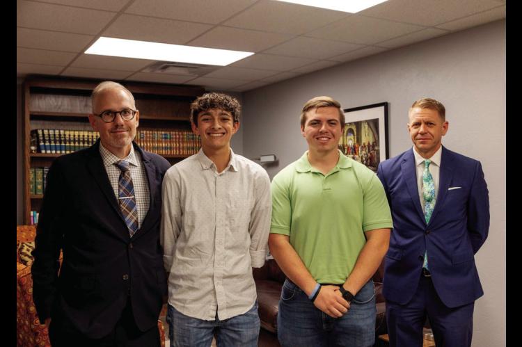From left, Dr. Ben Myers, director of the Oklahoma Baptist University honors program, is joined by OBU students Zadyn Joplin and Thomas Gage, and Mark Riley, owner of Walker Funeral and Cremation Services. (OBU photo)