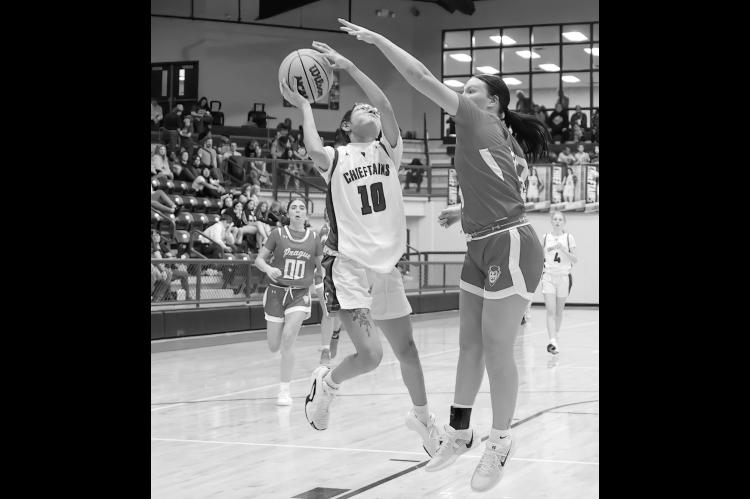 Seminole Lady Chieftain Molli Bustos fights for the shot against the Prague defender Tuesday. Courtesy Photo by Glen Bryan