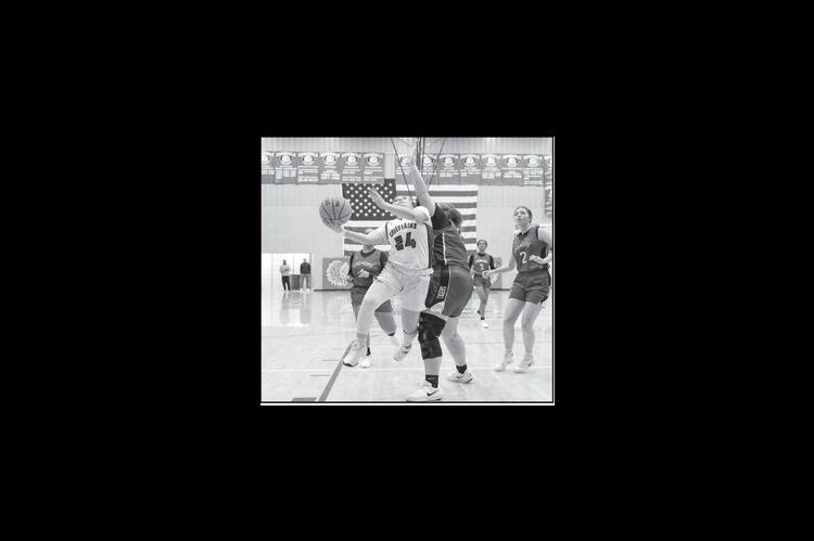 Courtesy Photo by Glen Bryan Seminole Lady Chieftain Aundrea Tagg drives down the lane to put up a shot.