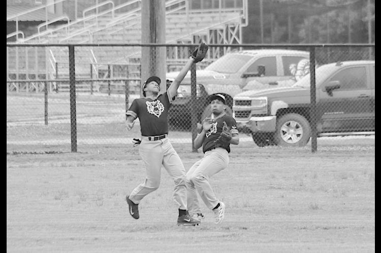 Wewoka Tiger LD Woods catches the pop fly with help of teammate Trae Woods Tuesday Staff Photo by Bill Anderson