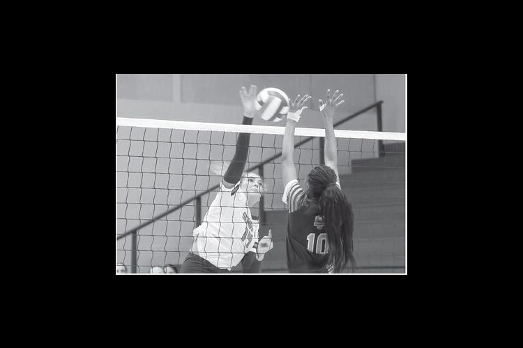 Seminole State Lady Trojan Caeli Schaefer tries to drive the ball past the defender. Courtesy Photo by Glen Bryan