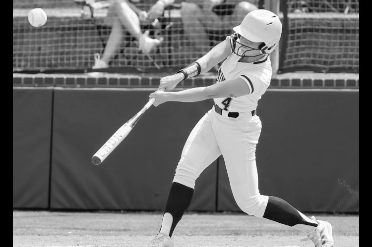 Seminole State Lady Trojan McKayla Greenshaw drives the ball into the outfield Courtesy Photo by Glen Bryan