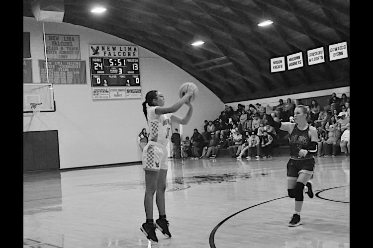 New Lima Falconette Jazzy Harjo shoots one of her many three-point shots Thursday night. Staff Photo by Bill Anderson