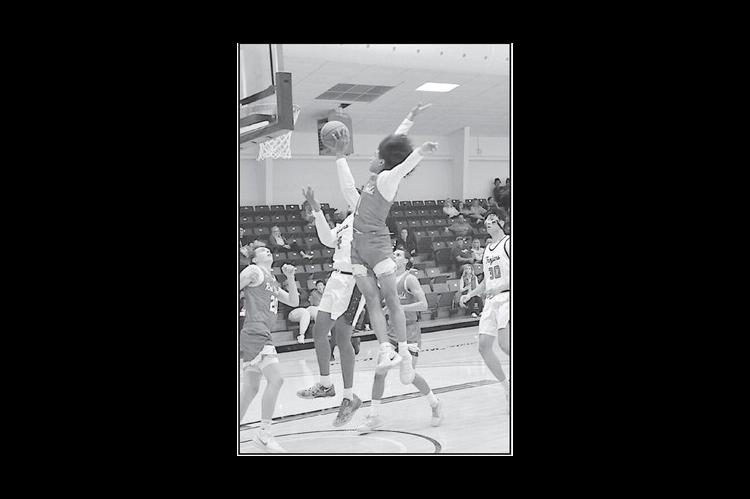 Seminole State Trojan Dylan Golightly fights off the Allen defender for the basket. Staff Photo by Bill Anderson