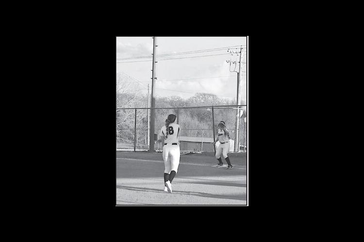 Konawa Lady Tiger pitcher throws the ball to teammate Bliss Henson to get the Allen runner out. Staff Photo by Andy Wilson