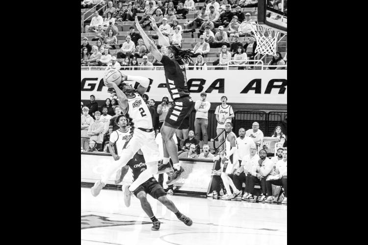 Courtesy Photo by Ben Shatzel Oklahoma State Cowboy Arturo Dean looks to score over the Cincinnati defender.