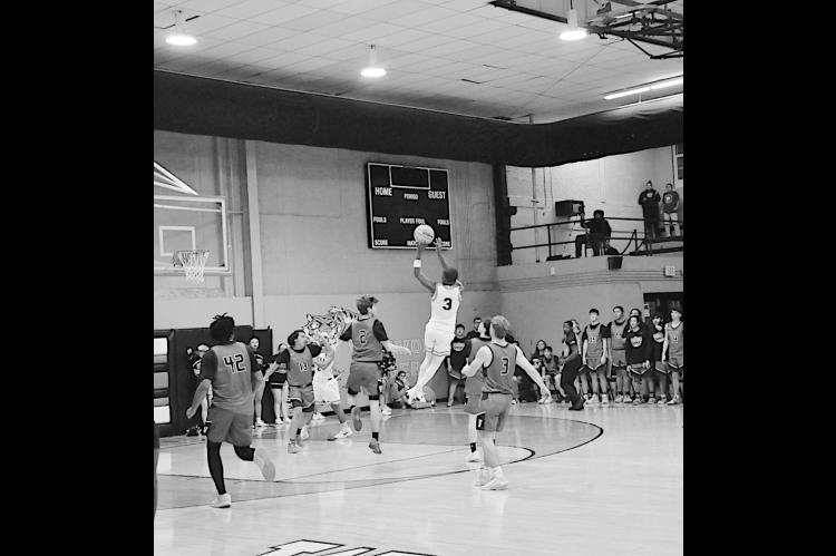 Wewoka Tiger Bill Stephens takes a shot right before the buzzer at the half. Staff Photo by Bill Anderson