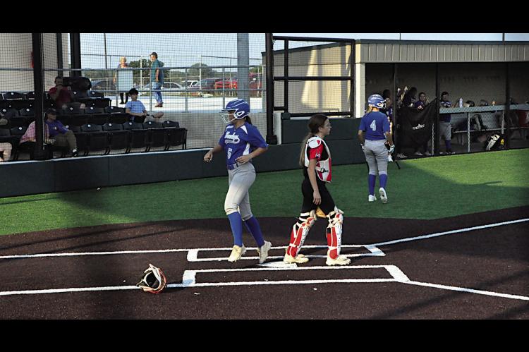 Bowlegs Lady Bison Kloe Oyler scores the run Thursday night at the LRC Tournament. Staff Photo by Bill Anderson