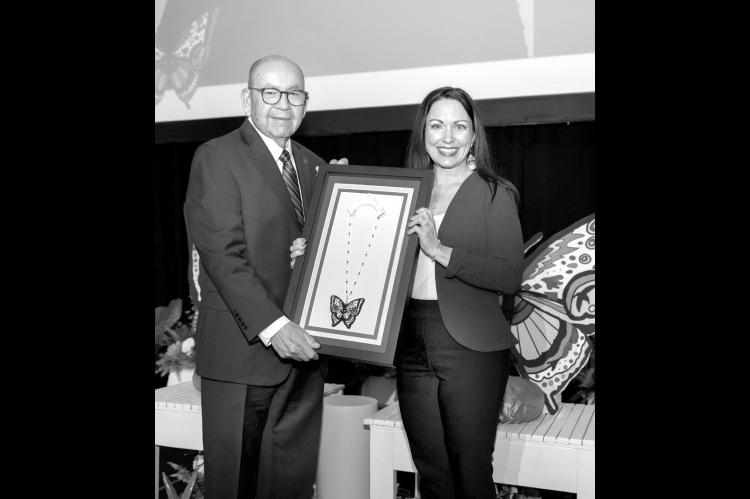 Chickasaw Nation Governor Emeritus Bill Anoatubby presents Dr. Kayla (Lewis) Robinson as the 2026 Chickasaw Nation Dynamic Woman of the Year during the annual Dynamic Women of the Chickasaw Nation Conference conducted May 28-29 at WinStar Resort and Convention Center. (Photo provided)