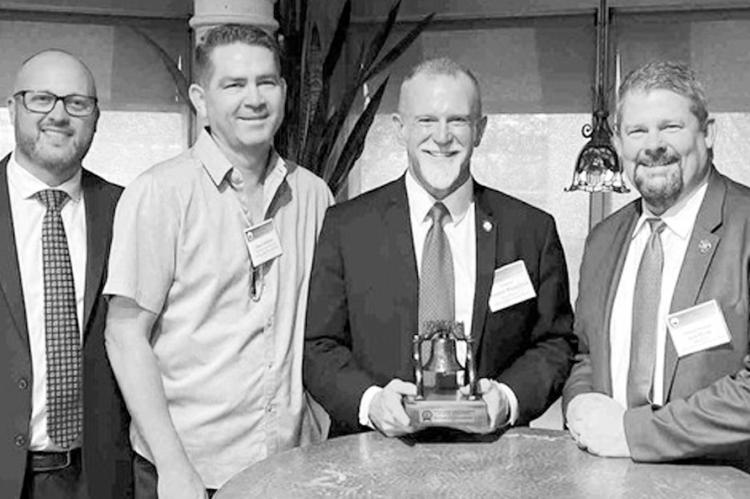 Senator Warren Hamilton, R-McCurtain, (center, with award) was recently presented the Liberty Bell Award by the Oklahoma District Attorney’s Association for his legislative efforts to protect Oklahoma’s children. (Courtesy photo)