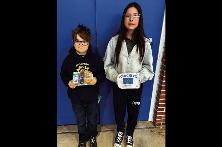 Pictured above are Academy of Seminole students Ryder Gurley and Kodi Lauderdale with samples of meals that are provided through a new partnership between the school and Feed the Children. (Photo courtesy of TAOS).