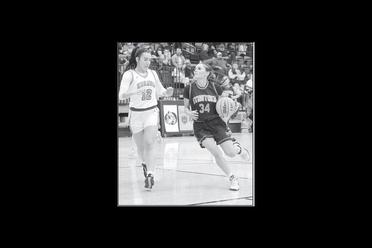 Strother’s Brooklyn Turner eyes the basket as she tries to get past Konawa’s Laila Wroolie. Courtesy Photo by Glen Bryan