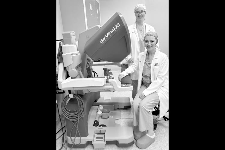 Dr. Amanda Schovanec, seated, and Dr. Danielle Manship at the robot control station at SSM Health St. Anthony Hospital – Shawnee. Surgeons operate the system using a console that translates their hand movements into smaller, highly precise movements of tiny instruments. (Provided)