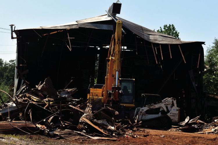 Demolition of a decades old Seminole landmark near the corner of Boren Boulevard and Strother Avenue got underway Thursday. The former U.S.A. Tank building, previously known as Independent Tank, is no more. Steel tanks used by the petroleum industry were 