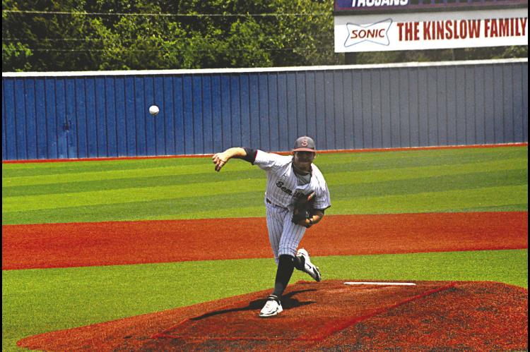 Seminole State Trojan pitcher Mathew Hudspeth throws the fast ball to St. Charles batter. Staff Photo by Bill Anderson