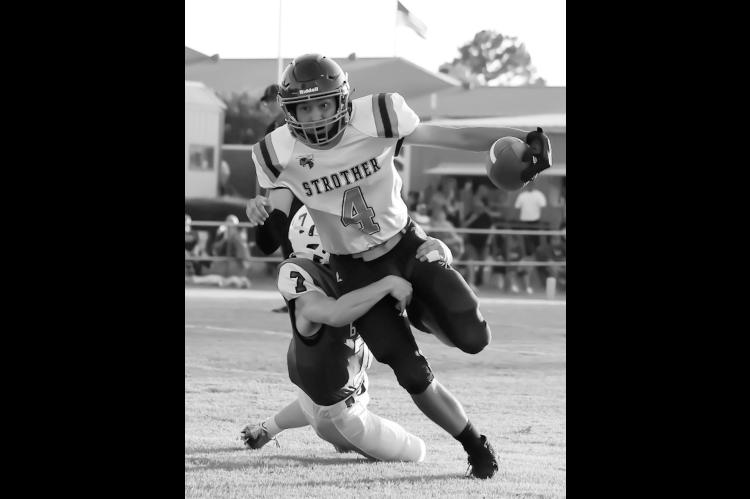 Strother Yellowjacket Owen Davis tries to bear free from Bowlegs George Harjo. Courtesy Photo by Glen Bryan